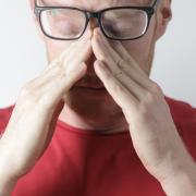 Generic image of man touching his nose