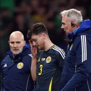 Andy Robertson looks dejected as he's subbed off injured