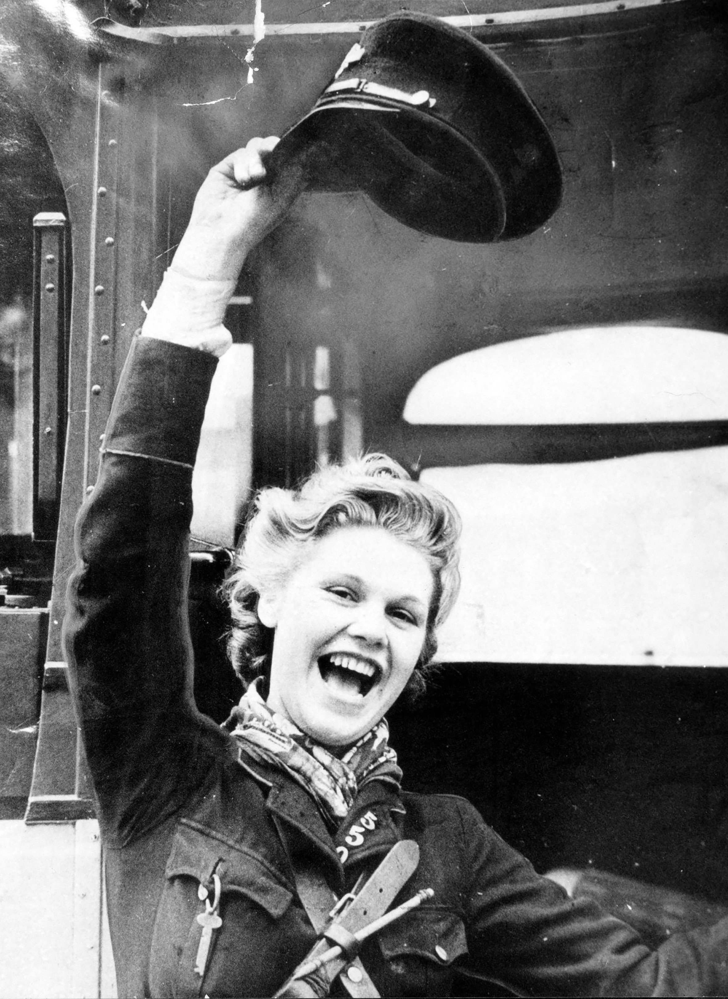 A Glasgow clippie showing her joy that the war is finally over on VE Day, 1945. 