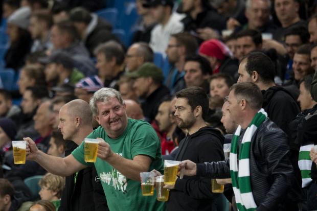 Supporters enjoy a beer at the game in Leipzig in Germany