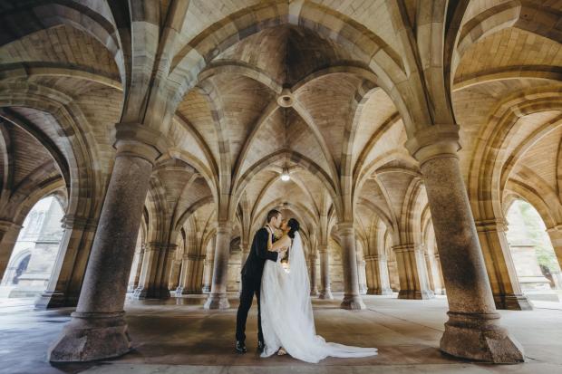 Glasgow Times: The happy couple, Yanling Zhu and Louie Liu in the famous Glasgow University arches. Pic: Gao Peng