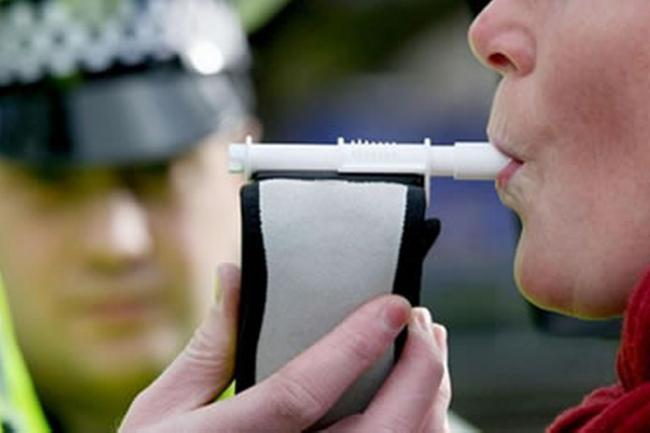 A breath test being carried out