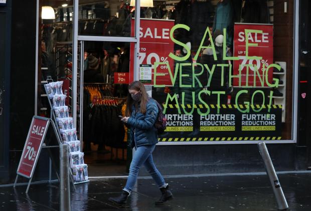 Glasgow Times: Member of the public wearing a face covering shopping on Buchanan Street in Glasgow (Image:PA, Dec 22)
