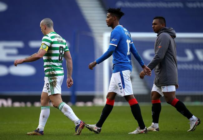 Celtic's Scott Brown and Rangers' Bongani Zungu leave the pitch after the final whistle during the Scottish Premiership match at Ibrox 