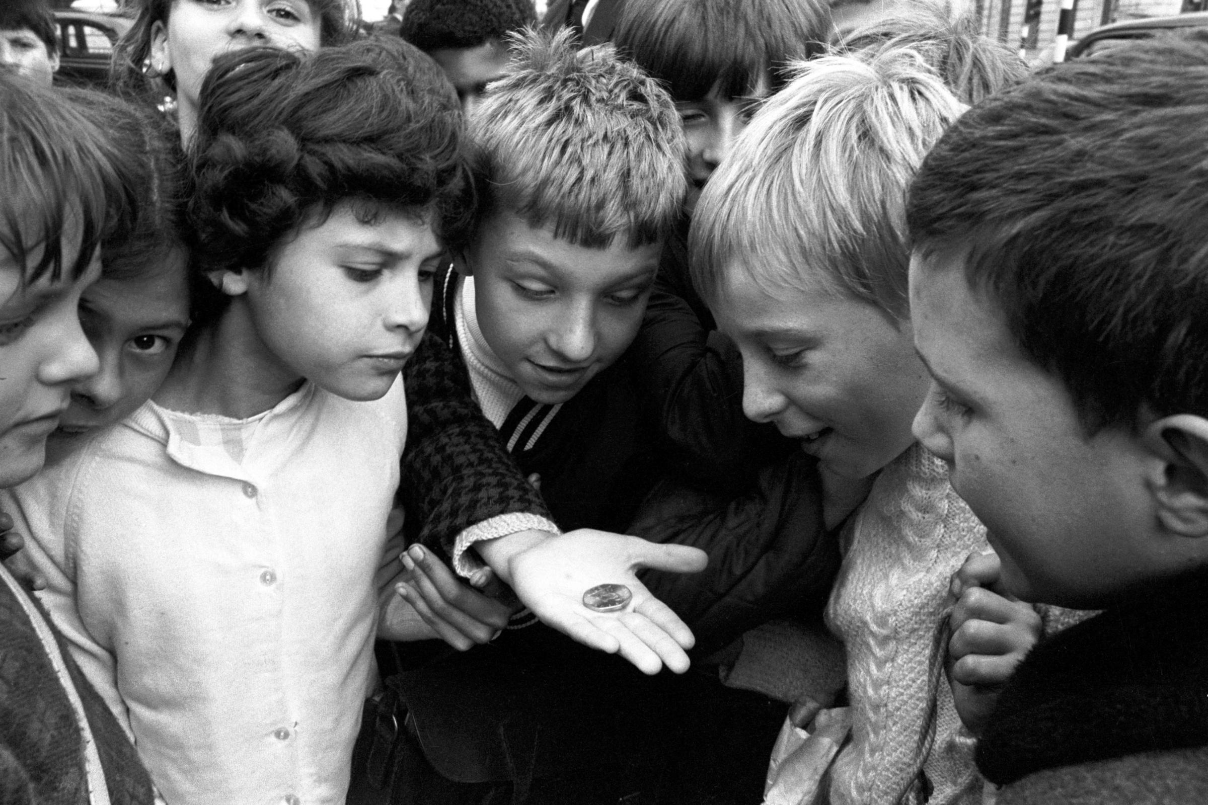Children in 1969 looking at the new decimal 50 pence coin, the worlds first seven sided coin. The switchover to decimal currency - a move which broke with centuries of monetary tradition - happened 50 years ago this month.