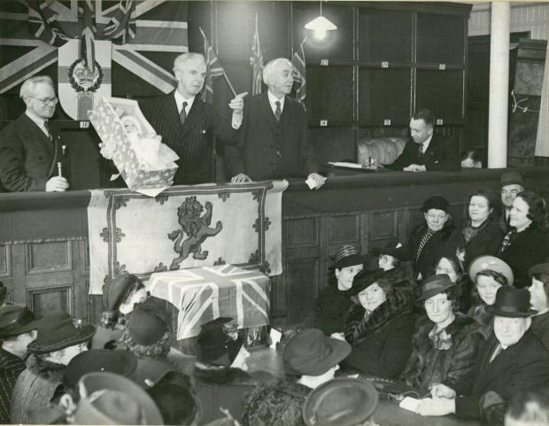 Glasgow Times: Patrick Dollan (holding doll) acting as an auctioneer at a charity event, 1941. Pic: Glasgow City Archives