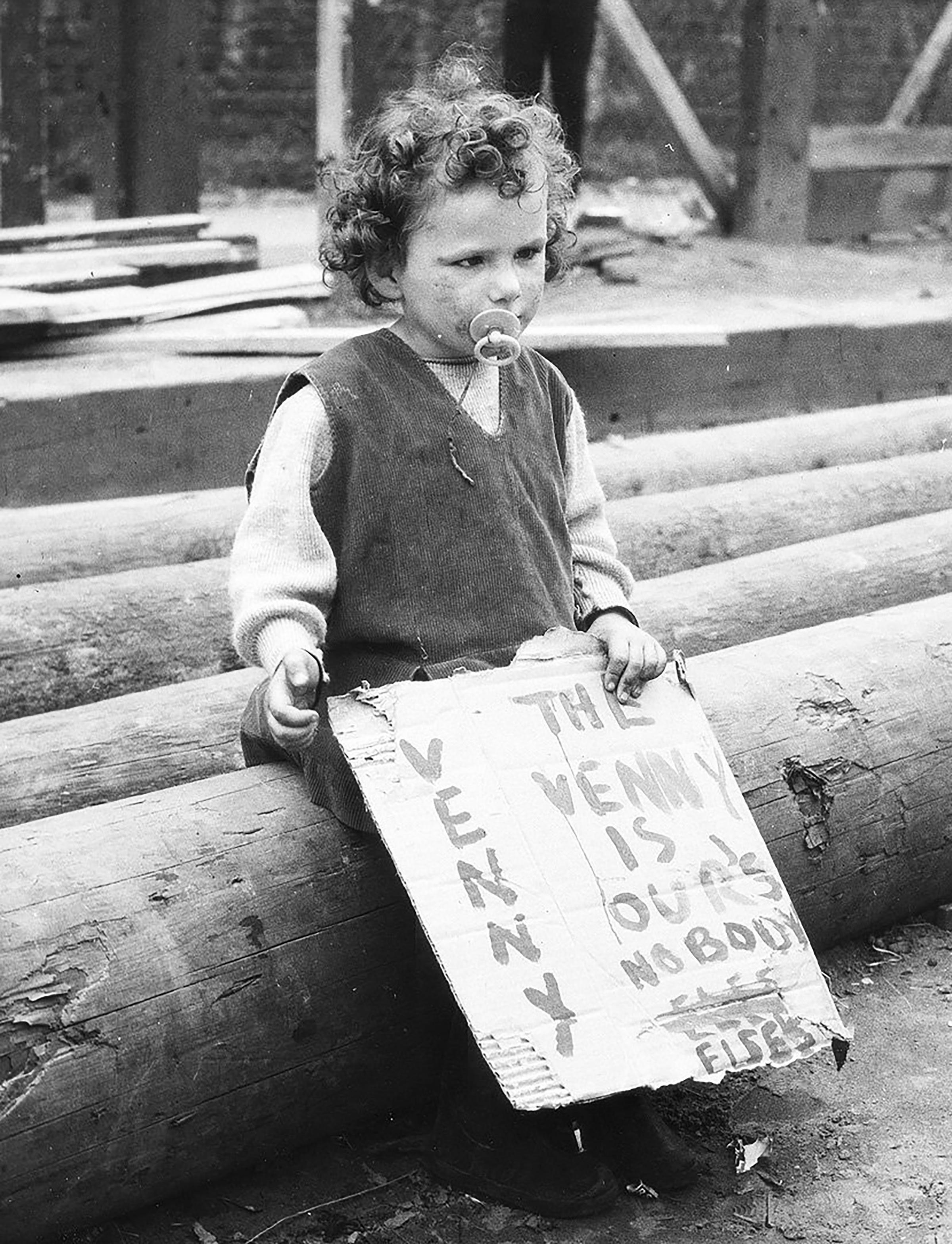A little girl with her home-made poster as part of the campaign to save the adventure playground in the Gorbals, in August 1967. Pic: Herald and Times