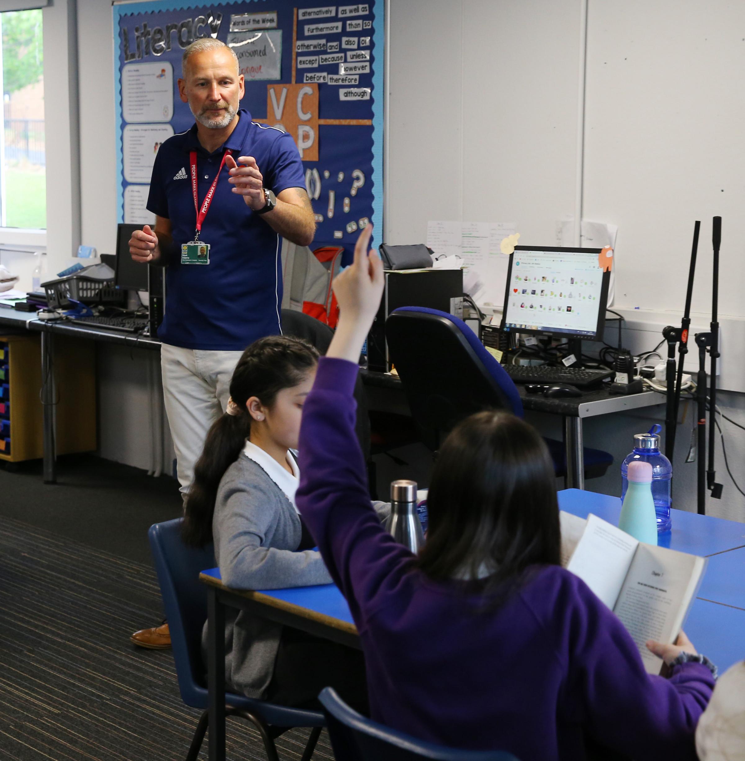 Mark Adams, project co-ordinator with Sense Over Sectarianism, pictured speaking to Darnley Primary school P6 pupils who are reading copies of Divided City by Theresa Breslin Picture: Colin Mearns