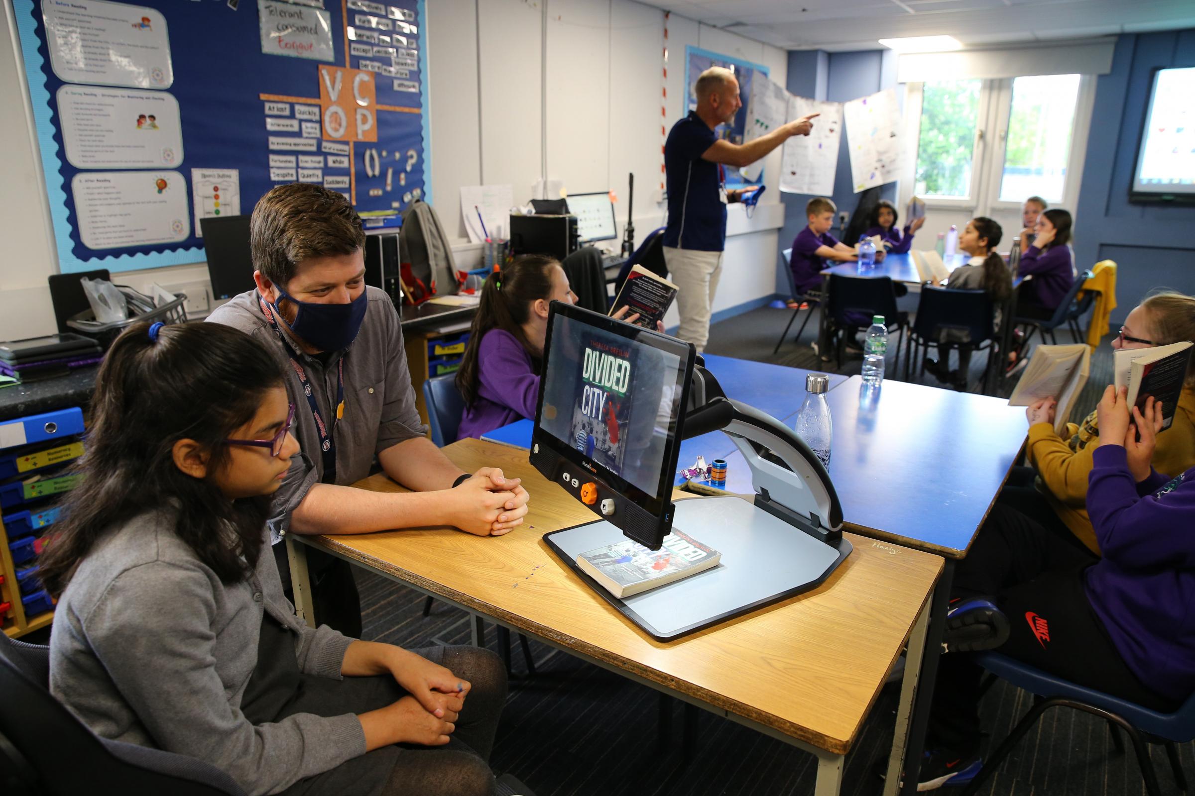 Mark Adams (middle of frame) project co-ordinator with Sense Over Sectarianism pictured speaking to Darnley Primary school P6 pupils. In foreground left is class teacher Martin Walker with Haniya Akhter age 11 Picture: Colin Mearns