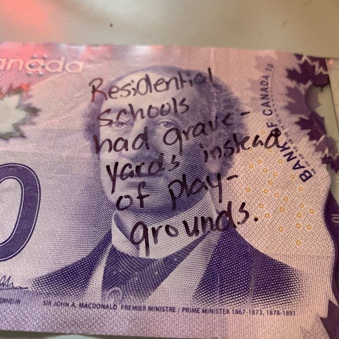 Canadas $10 bill has a picture of John A Macdonald and some register their protest to his legacy by defacing it. Image courtesy Bryson Syliboy