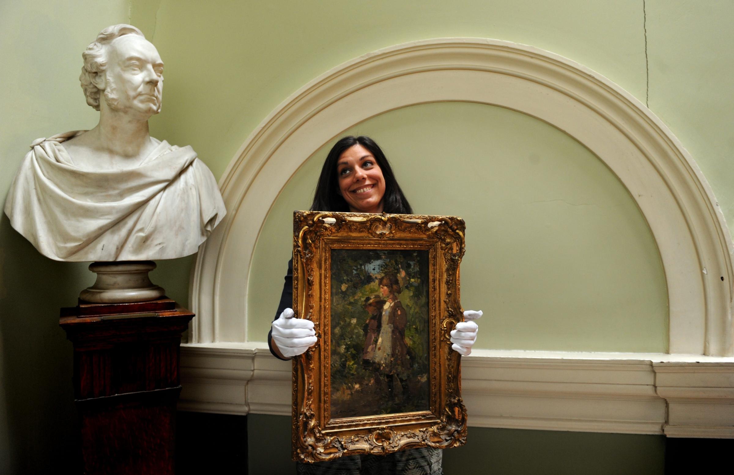Glasgow Boys Paintings on view at The Royal Faculty of Procurators, Nelson Mandela Place Glasgow. Camillla Riva 27 from Milan holdind a Painting titled The Schoolmates by Edward Arthur Walton valued at £40-60,000. Pictures: Herald and Times