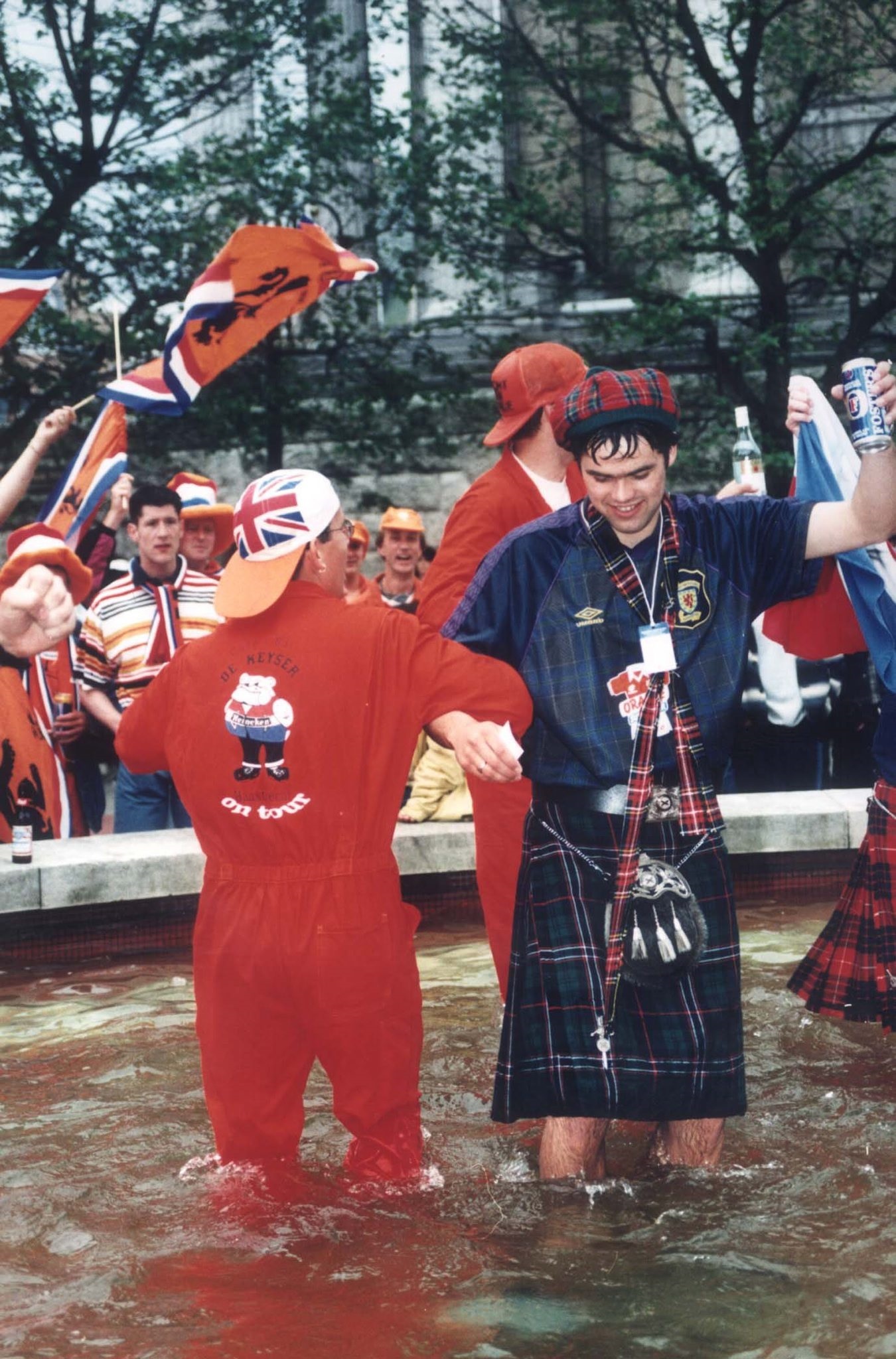 A Dutch fan and a Scottish fan dance in a Birmingham fountain, 1996. Pic: Herald and Times