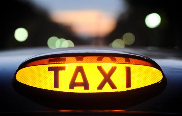 Glasgow Times: A light on a London taxi during a demonstation in central London against regulation of private hire taxis..