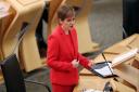 First Minister Nicola Sturgeon giving an update on Covid restrictions in the Scottish Parliament, Edinburgh. PA Photo. Picture date: Tuesday December 22, 2020. See PA story SCOTLAND Coronavirus. Photo credit should read: Russell Cheyne/PA Wire.