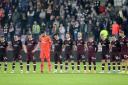 Hearts players observe a minute's silence before the start of the second-half at Tynecastle