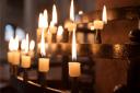 Generic image of candles in a church