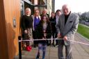 Chris Lee, 97, accompanied by Molly Henderson, 10, officially open the Hub