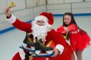 Paisley figure skater Lacey Millar, aged nine, with Santa at Paisley's Christmas ice rink in County Square at last year's event