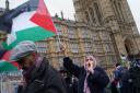 People take part in a Palestine Solidarity Campaign rally outside the Houses of Parliament in February