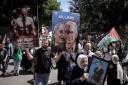 Palestinians carry placards during a rally marking the annual prisoners’ day in the West Bank city of Nablus
