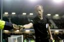 Willie Collum removes a glass bottle that was thrown at Scott Sinclair