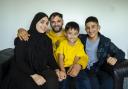 Zabidullah Rasoli pictured with his wife Tabasum at home in Glasgow, alongside Tabasum's nephews, Mohammad age 6 and Zekrullah age 16