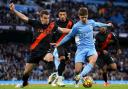 Manchester City's James McAtee (right) and Everton's Seamus Coleman battle for the ball during the Premier League match at the Etihad Stadium
