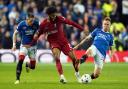 Liverpool's Joe Gomez battles for the ball with Rangers Ryan Kent (left) and Scott Arfield (right) during the UEFA Champions League Group A match