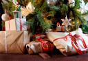 EMBARGOED TO 0001 THURSDAY OCTOBER 27 File photo dated 25/12/19 of wrapped Christmas presents under a Christmas tree, as more than two thirds of UK adults are planning to cut back on their spending this Christmas due to the cost of living, a survey