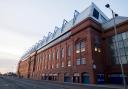 TV star poses outside Ibrox Stadium with Rangers scarf