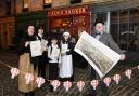Niall Murphy,  with map, and Rachel Kacir, left, of director of Glasgow City Heritage Trust, with pupils