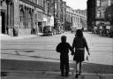Two children take their ginger bottles back to the shop, Glasgow, 1963