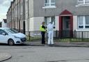 Man dies after being found injured at Glasgow flat as forensics comb scene