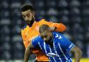 Kyle Vassell holds off Connor Goldson