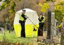 Police officers at the scene in Cardonald Cemetery, Glasgow