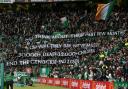 The Green Brigade hold up banners at Parkhead on Saturday
