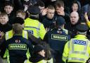 Police and stewards attempt to control the crowd at Tynecastle on Wednesday night