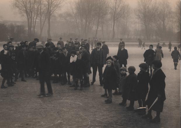 Glasgow Times: Children watching an ice skater on the frozen pond at Victoria Park, December 1925 Pic: Glasgow City Archives