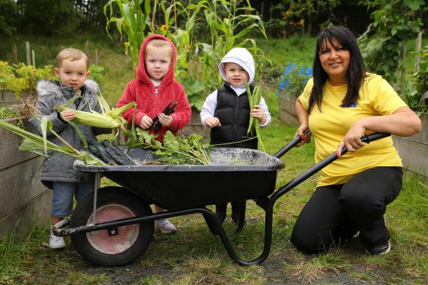 Streets Ahead feature on Lochend Community Allotment in Easterhouse, Glasgow. Pictured is Susan Wilson, a gardener volunteer at the allotment pictured with children from FARE Play nursery, from left- Beau, Iona and Millen all age 3...Photograph by Colin