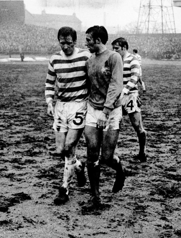 Glasgow Times: McNeill of Celtic and McKinnon of Rangers walk off at the end of the match.