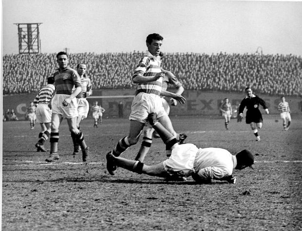 Glasgow Times: Renicci, Partick Thistle's keeper dives to save at the feet of Billy McPhail of Celtic. Pic: Newsquest