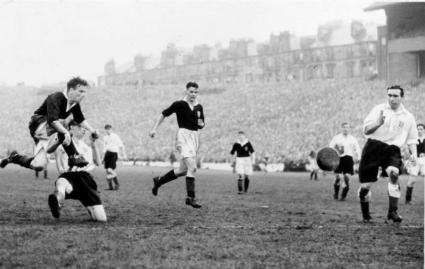 Glasgow Times: Lawrie Reilly scores as Alf Ramsey watches..the match ended 2 - 1 to England....