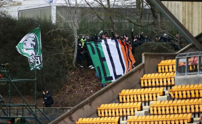 Celtic supporters watch on from outside McDiarmid Park with attendances limited to just 500 on Boxing Day.