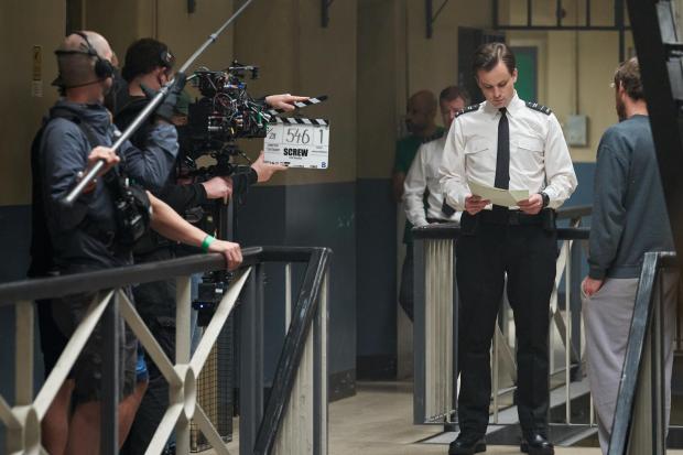 Glasgow Times: Actor Jack Bardoe shoots a scene during filming of drama series Screw at the Kelvin Hall in Glasgow. Picture: STV Studios/Channel 4
