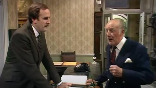 Glasgow Times: John Cleese as hotelier Basil Fawlty and Ballard Berkeley as Major Gowen in BBC sitcom Fawlty Towers. Picture: BBC