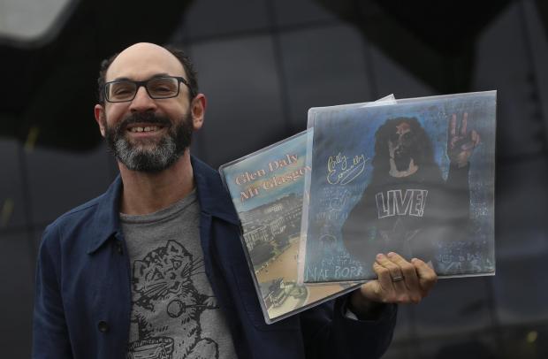 Glasgow Times: Neil Johnson-Symington, curator of the new Glasgow music shop scene exhibition at the Riverside Museum in Glasgow on Wednesday.  ..Pic Gordon Terris Herald & Times..2/3/22.