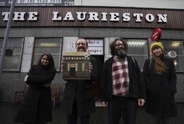 Glasgow Times: Album Club members with the vinyl cover depicting the Laurieston Bar. From left: Emma Pollock, MJ McCarthy, Adam John Scott and Rhona Dougall. Pictures: Gordon Terris
