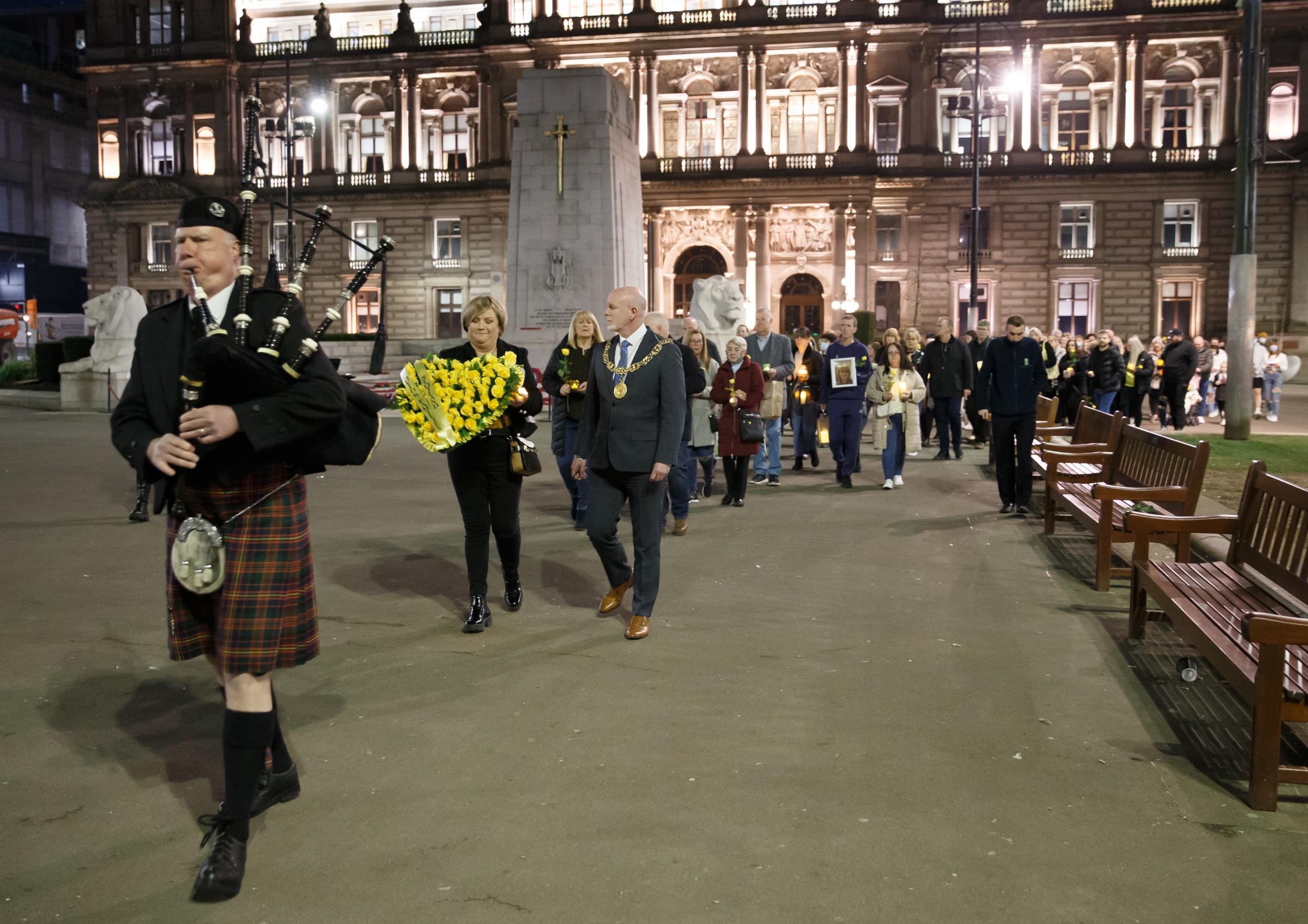 Vigil at George Square, Glasgow to mark the second national lockdown anniversary. The event attended by families who lost loved ones in the covid pandemic was organised by Covid 19 Families Scotland. Pictured is a piper leading the vigil into the square,