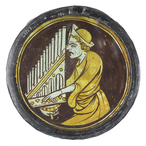 Glasgow Times: A stained-glass roundel, circa mid-1300s, depicting a man playing an organ. Picture: CSG CIC Glasgow Museums Collections