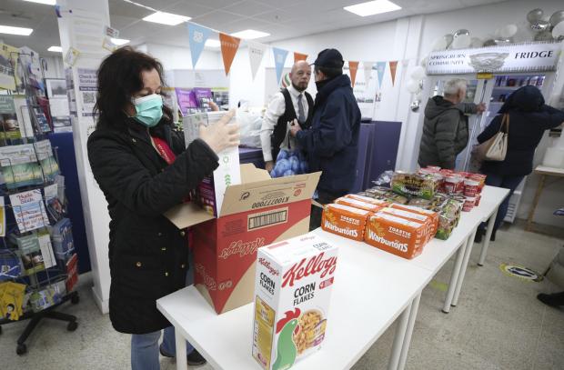 Glasgow Times: Volunteers give out food supplies to service users.